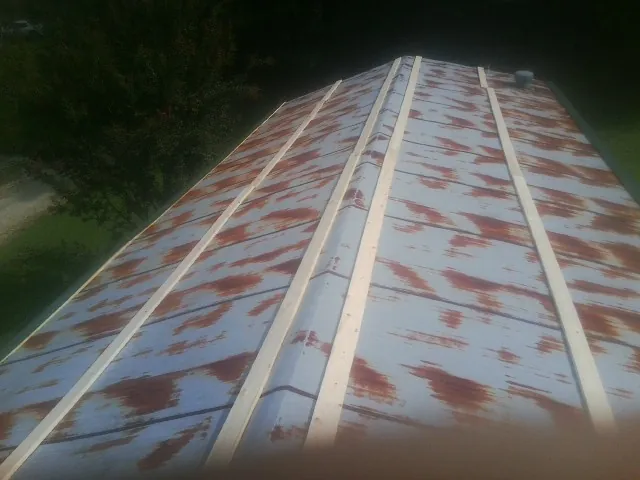 Rusted metal roof panels with new wood purlins before replacement — Storm Damage Roof Repair in Greenback by Roofing Brothers