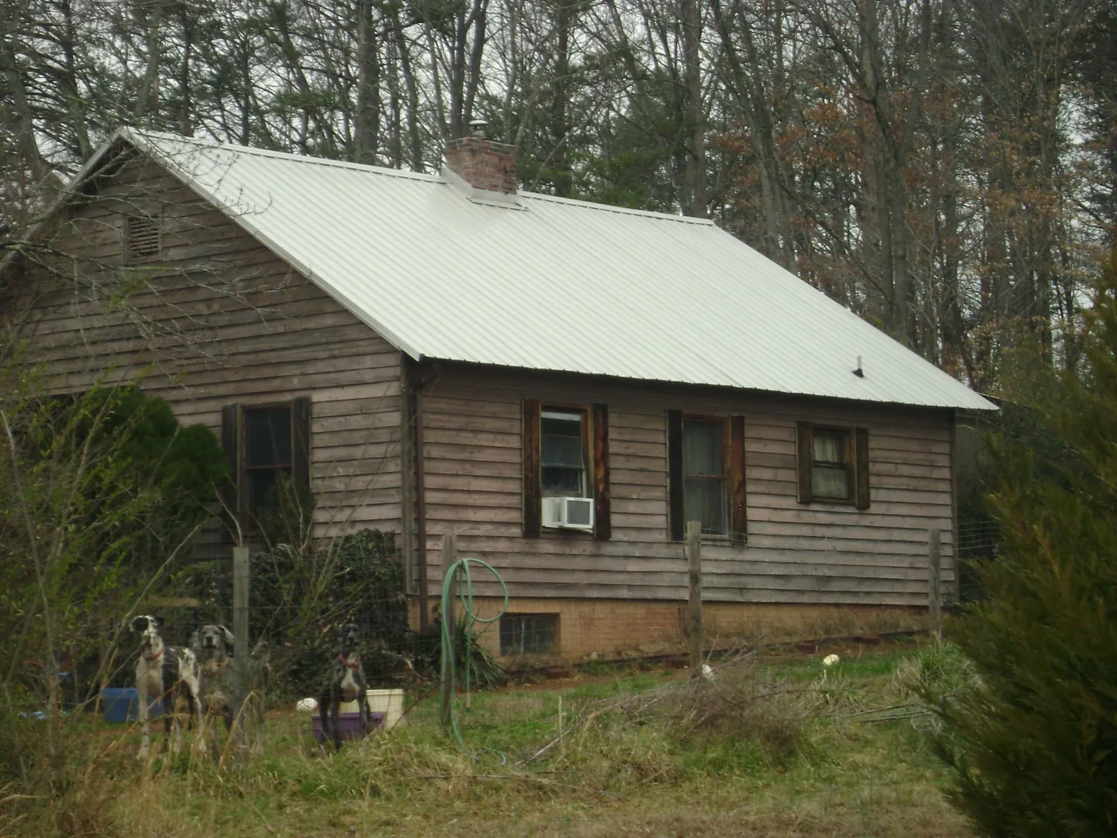 White metal roof on an old wood sided farmhouse, from a Metal Roof Installation job in Greenback